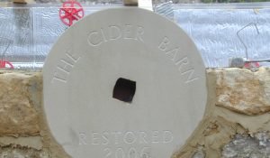 Orignal grinding stone now engraved and attached to the outside wall